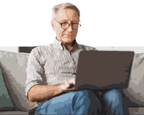 a man in glasses sitting down and using a laptop computer.