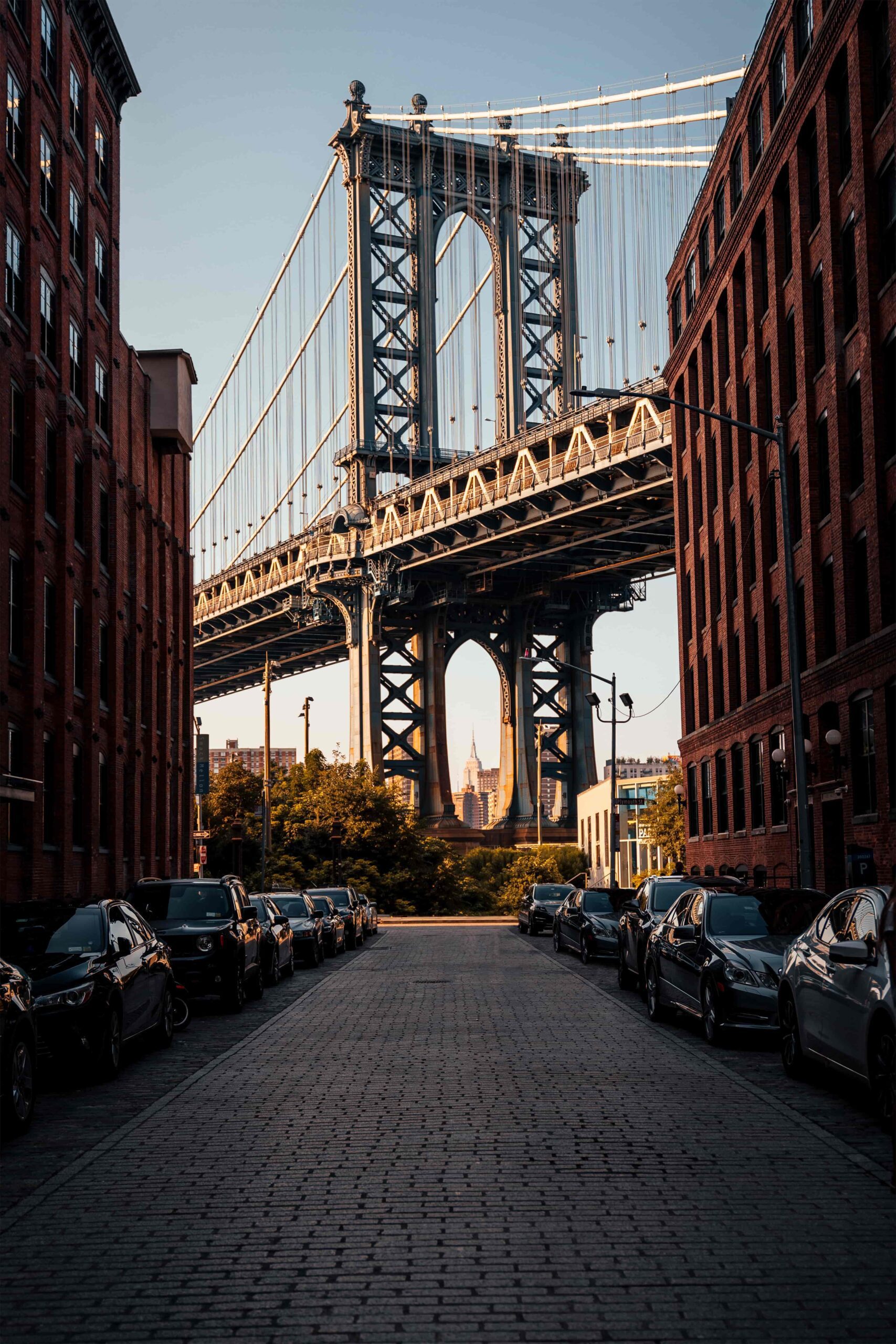 Photo of Brooklyn Bridge flanked by buildings in Brooklyn, New York