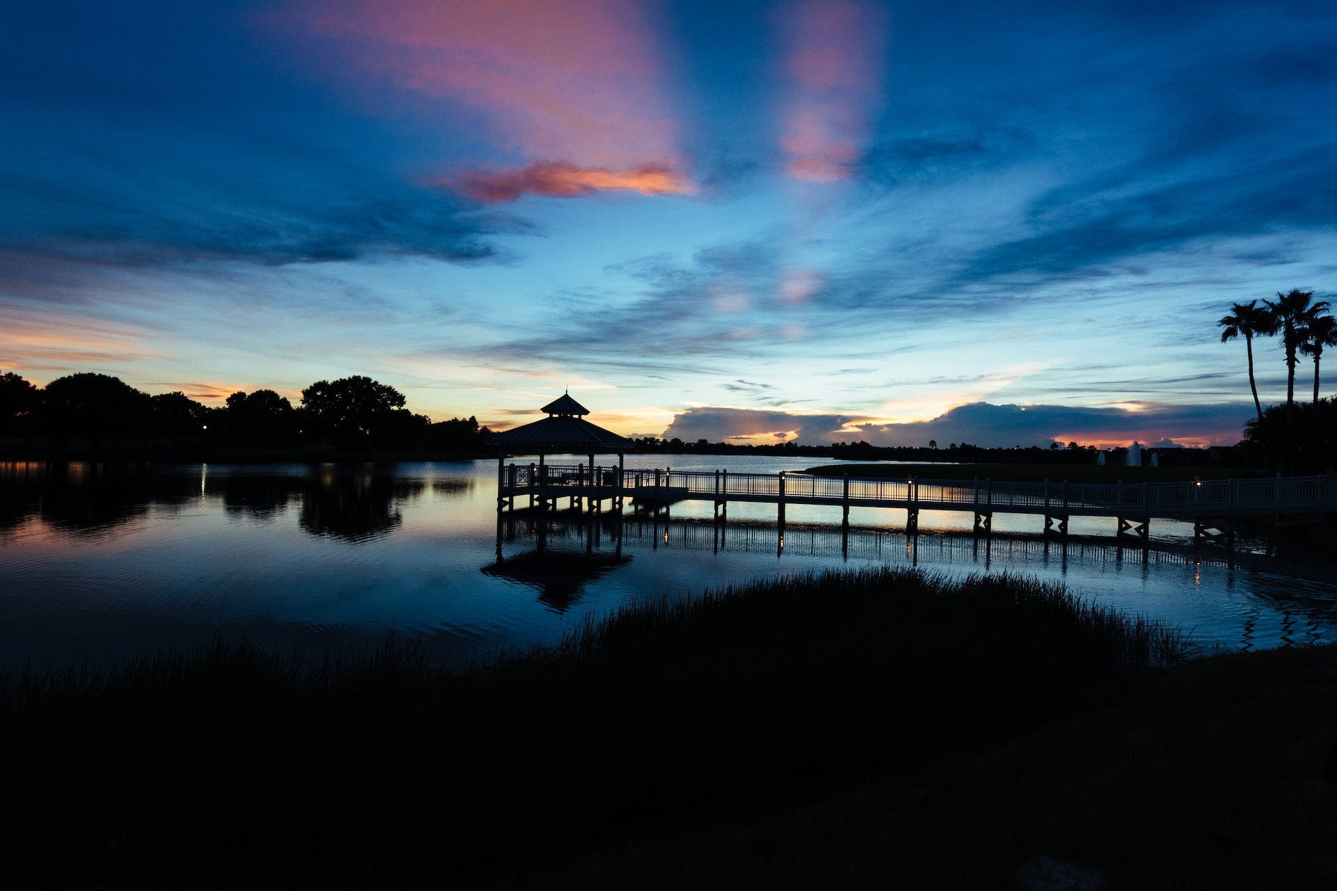 A dock with palms at sunset near Port St Lucie, Florida.