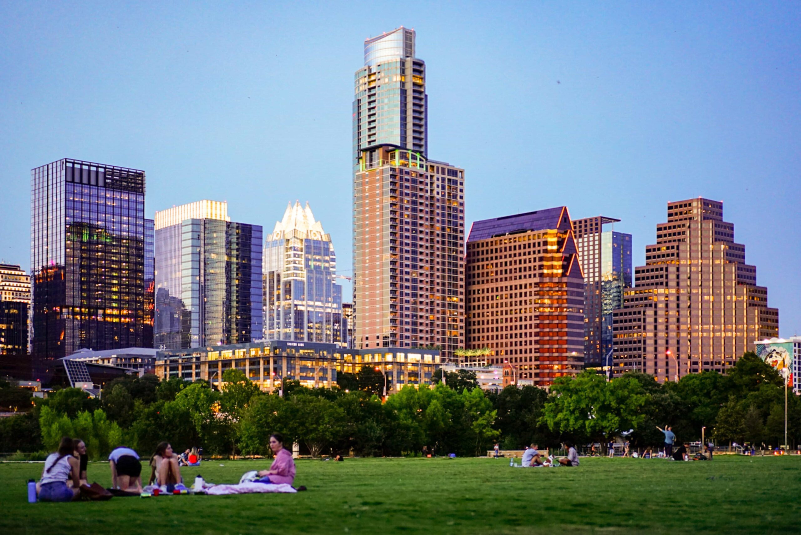 Austin, Texas skyline with a park in the foreground with individuals.