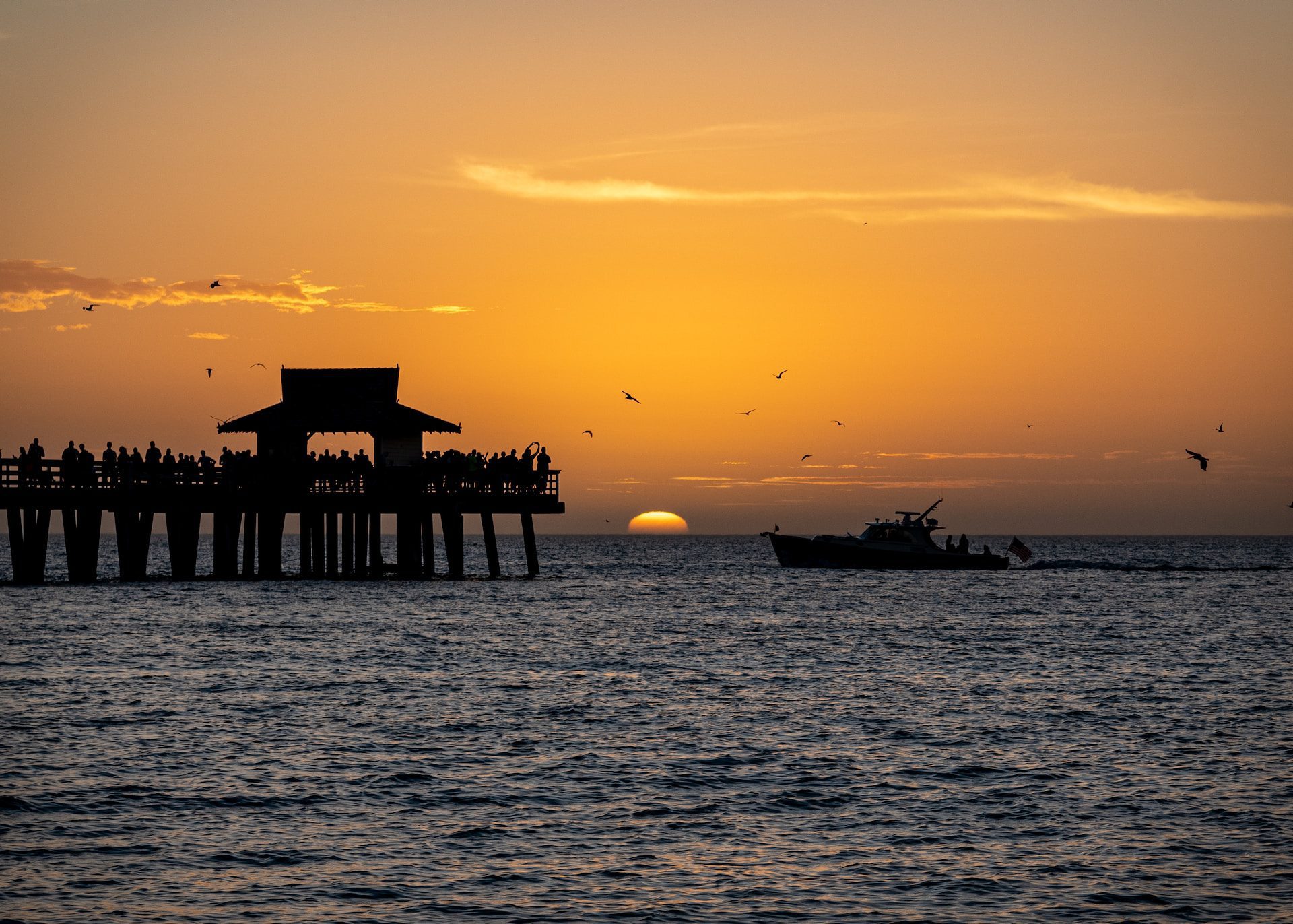 Sunset at Naples Pier in Naples, Florida.