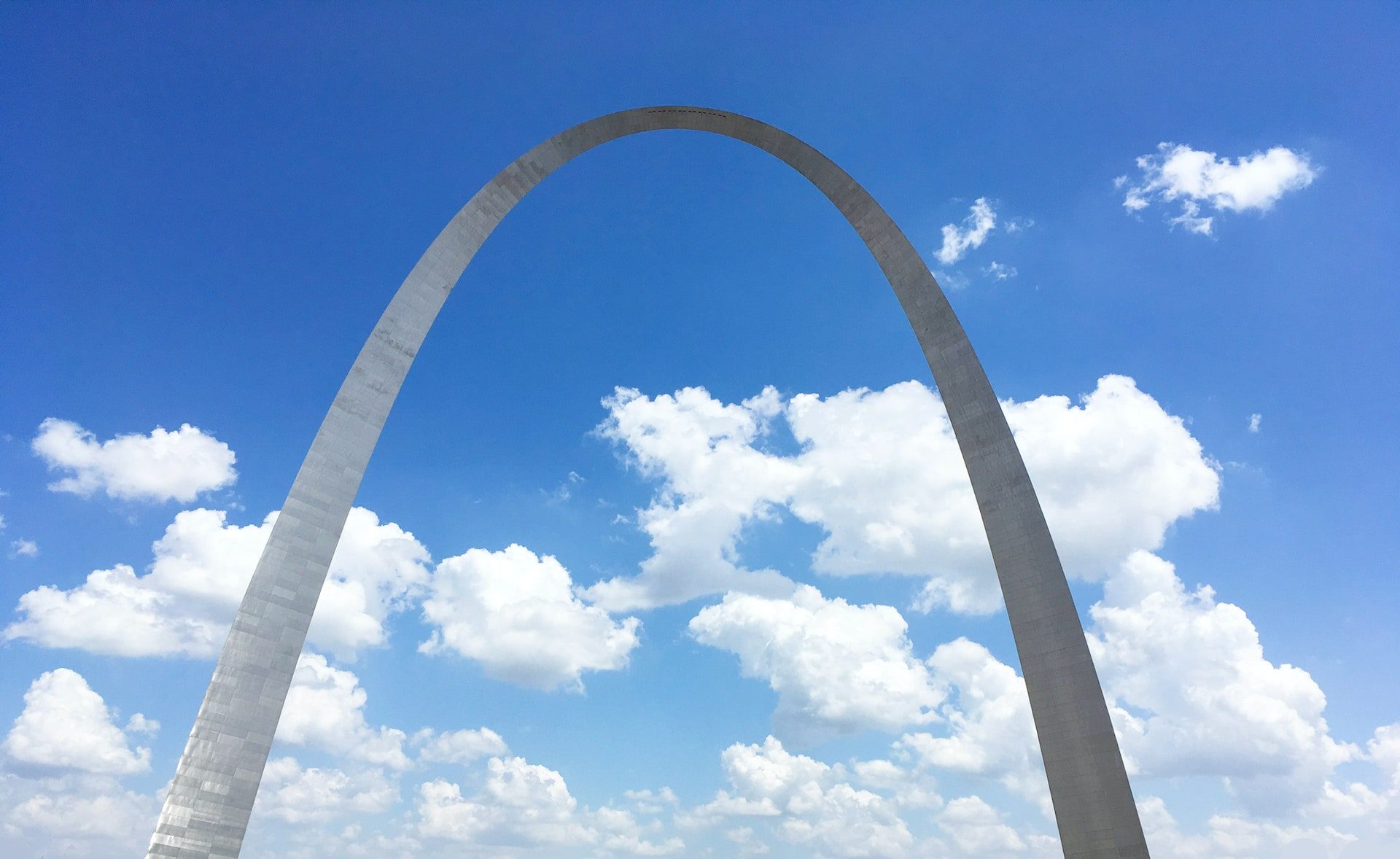 Blue sky with clouds framing the Gateway Arch in Saint Louis, Missouri