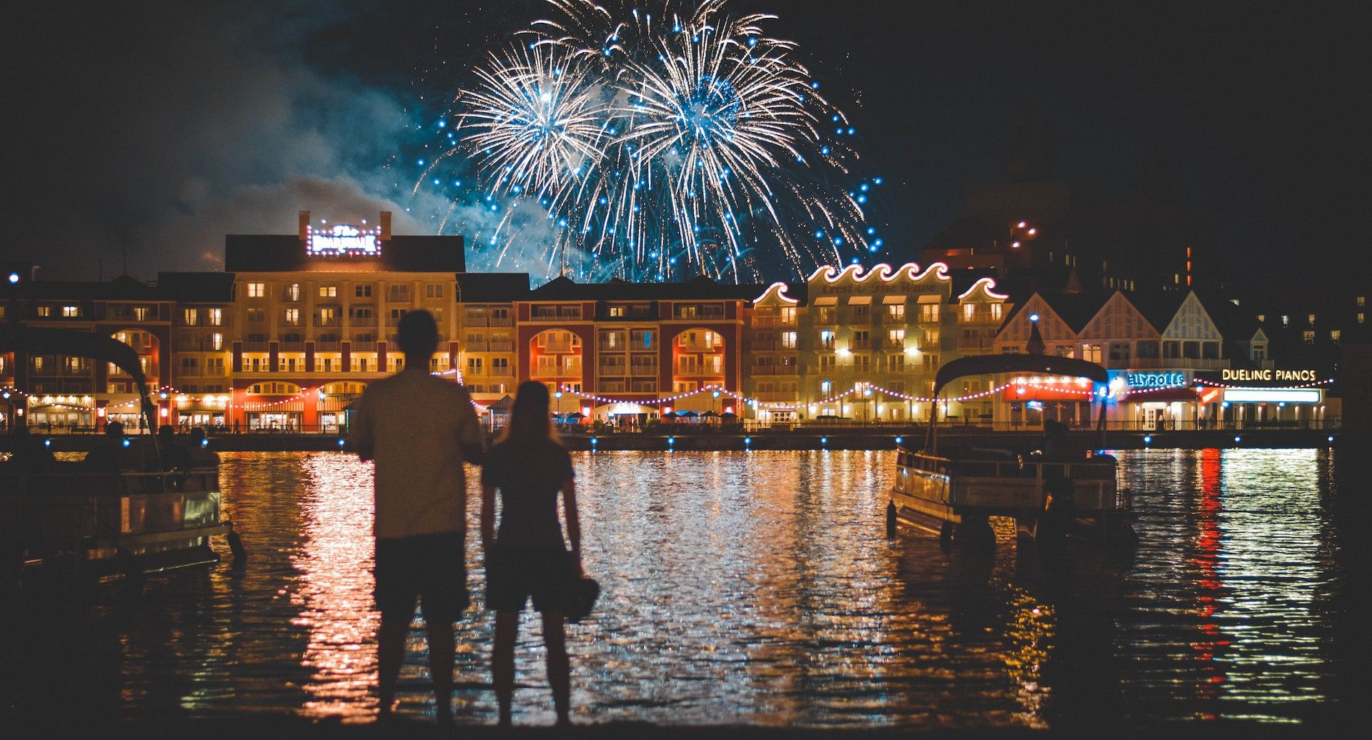 Two people watching fireworks at Disney in Kissimmee, Florida.