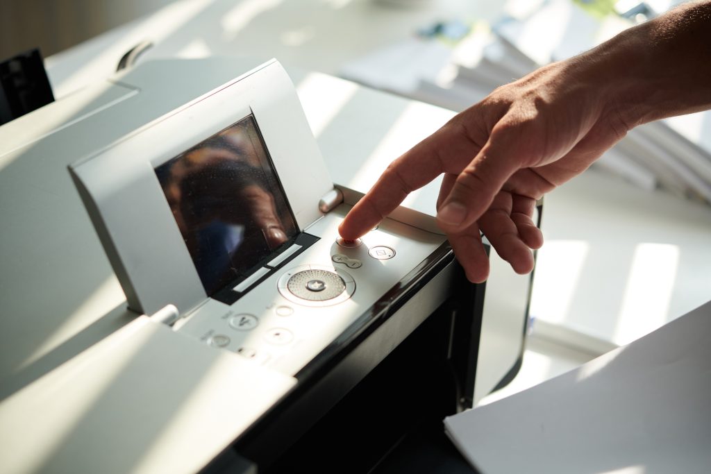 person using one of the top printers for a home office