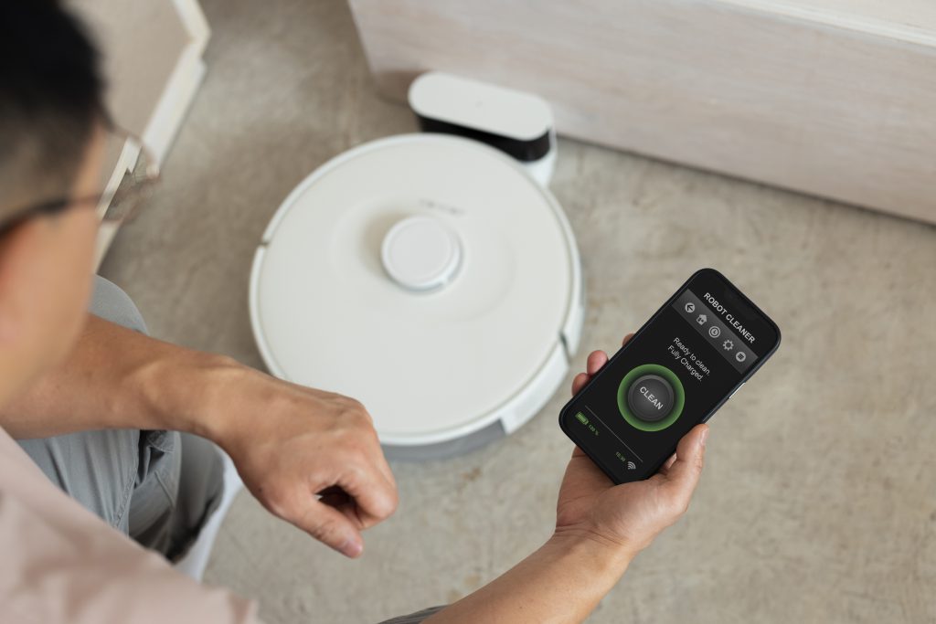 high-angle-man-with-robotic-vacuum-cleaner-home