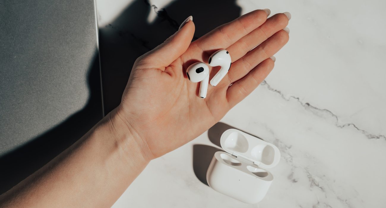 AirPods out of the charging case and ready to pair with a Dell laptop