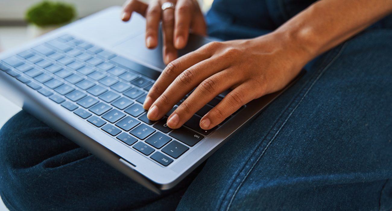 Person adjusting display resolution and scaling settings on a MacBook