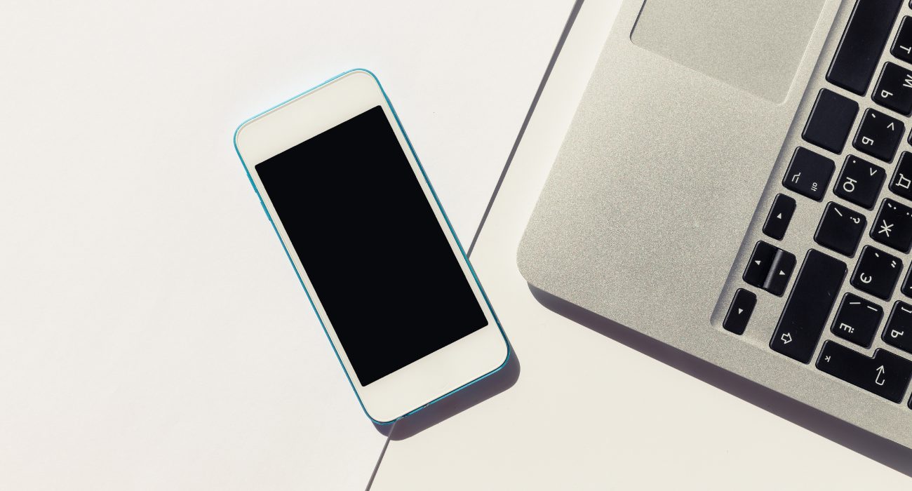 Smartphone connected to Wi-Fi next to a laptop showing a wireless connection issue