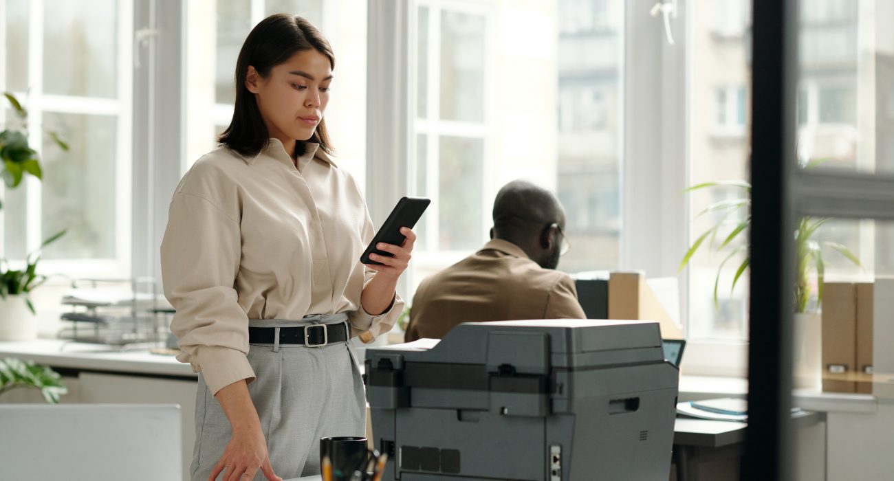 Woman trying to print from her smartphone while a wireless printer won't connect