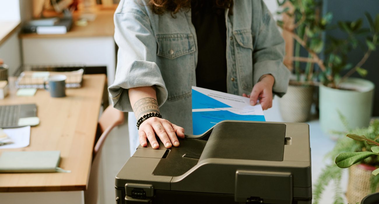 Person checking a home printer after a printer in use error