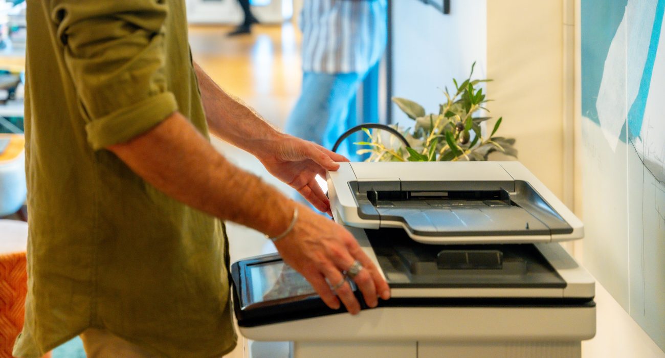 Person restarting a printer to clear a printer in use error